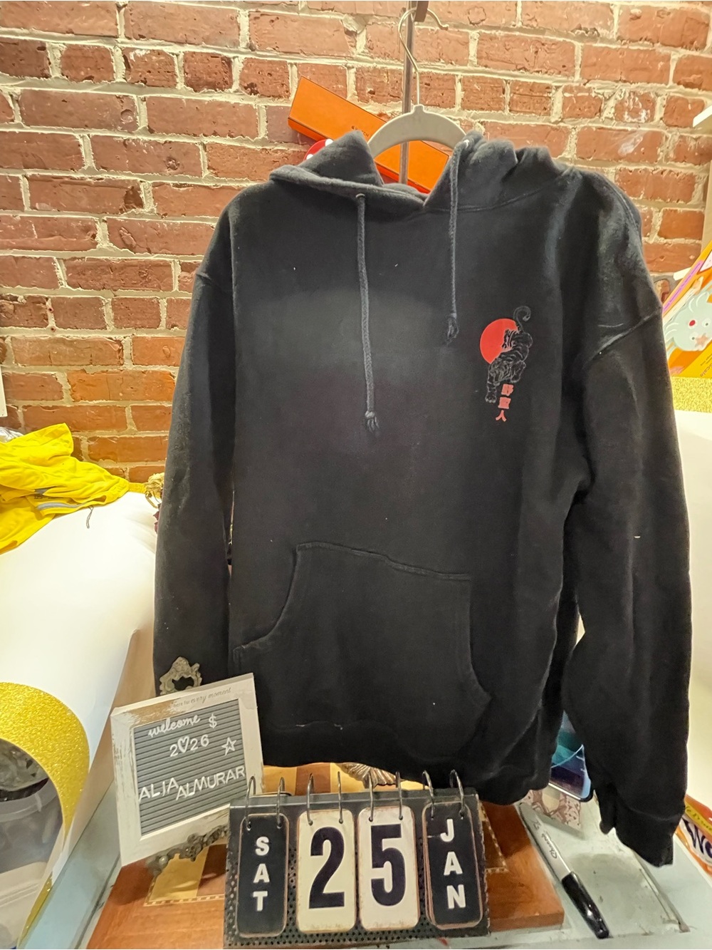 Men's Black Graphic Hoodie with Red Sun Accent